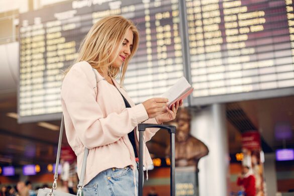 Woman looking for money-saving travel tips at the airport